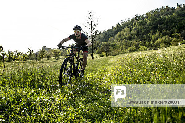 Man riding mountain bike in nature in the Bologna countryside  Italy