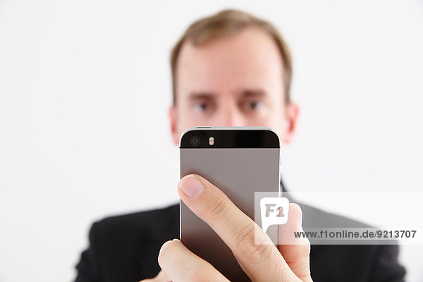 Businessman in a suit with smartphone