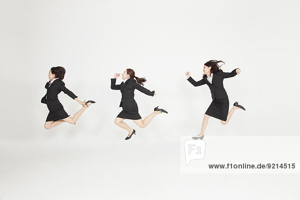Japanese business people jumping