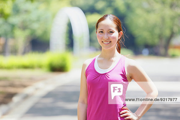 Young Japanese girl in fitness clothes in the park