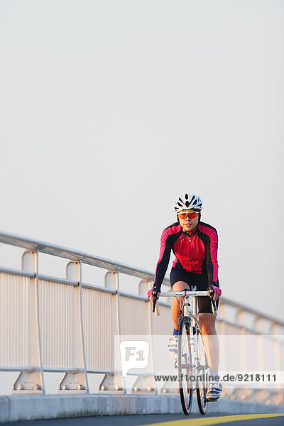Young Japanese girl cycling