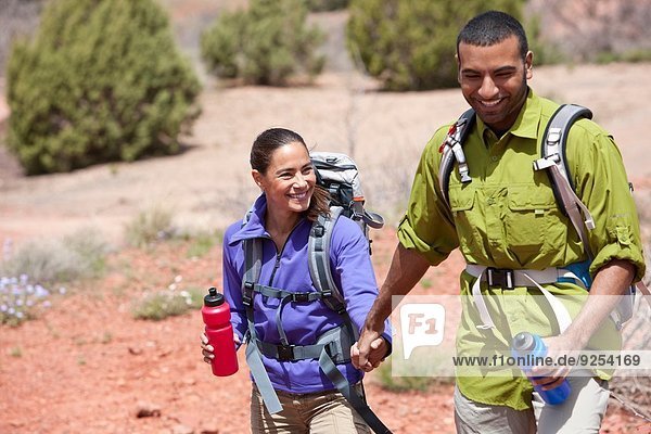 Couple holding hands out hiking  Sedona  Arizona  USA