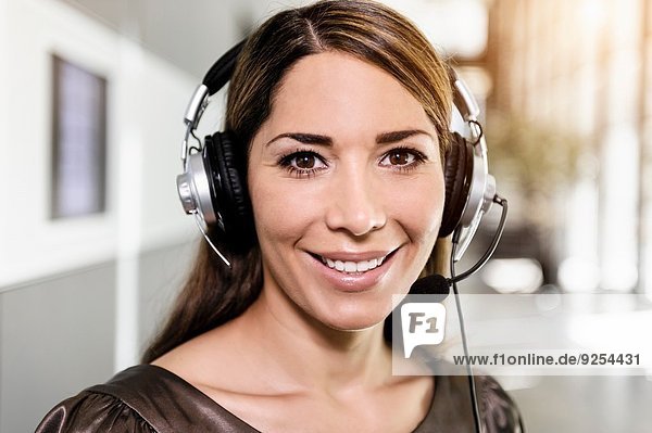 Portrait of mid adult businesswoman using telephone headset