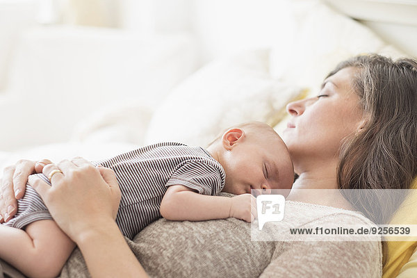 Mother with baby boy (2-5 months) taking nap together
