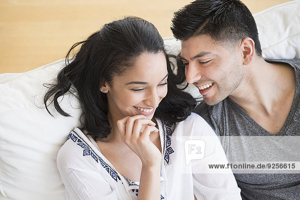 Happy young couple on sofa