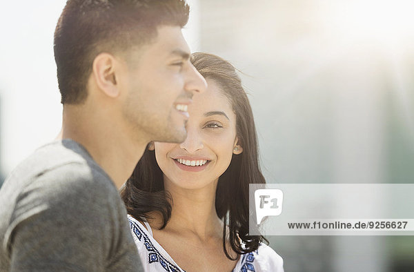 Young couple smiling in sunlight