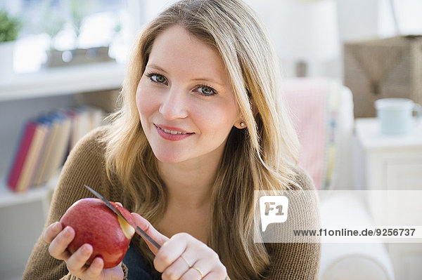 Woman peeling apple