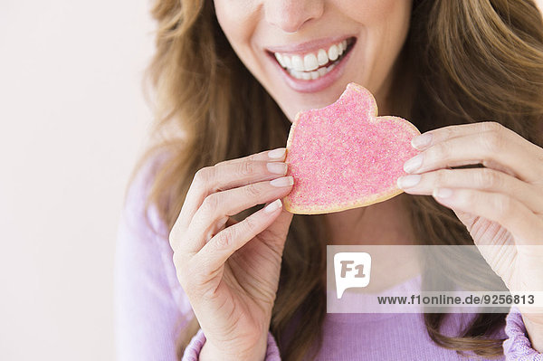 Woman holding heart shape cookie