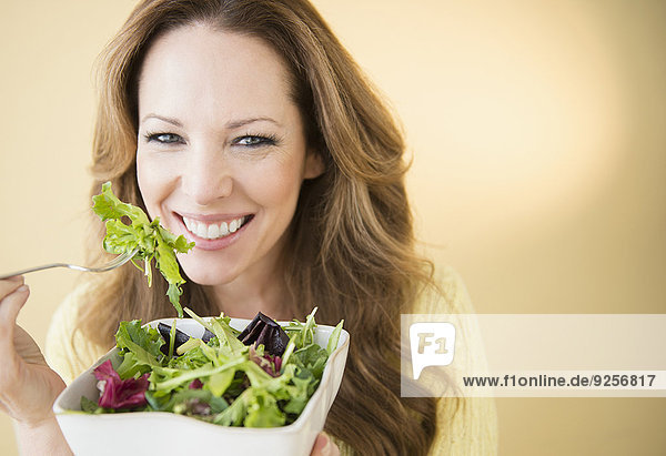 Portrait of woman eating salad