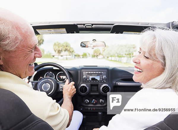Senior couple in convertible car