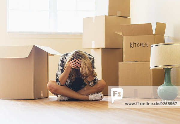 Young woman during moving into new house