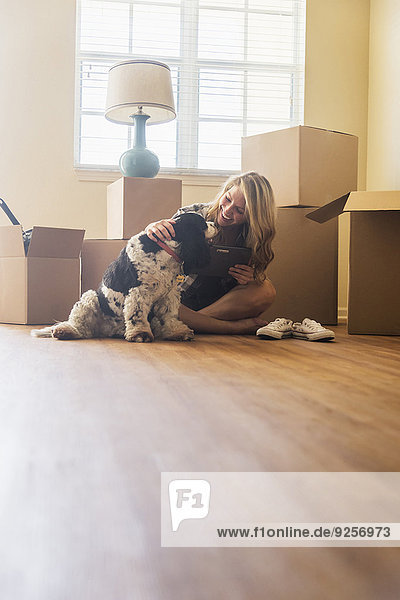 Young woman with dog in their new house