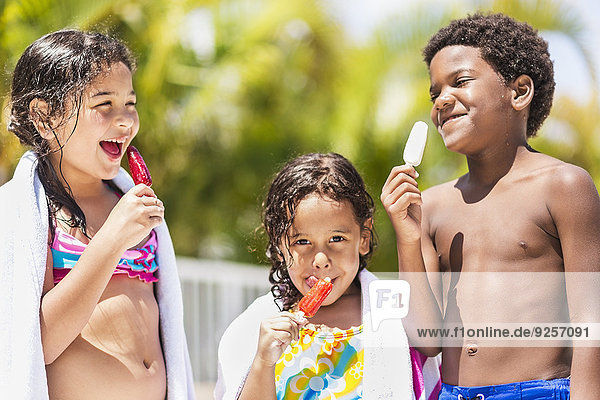 Kids( 4-5  6-7  8-9) eating ice-creams