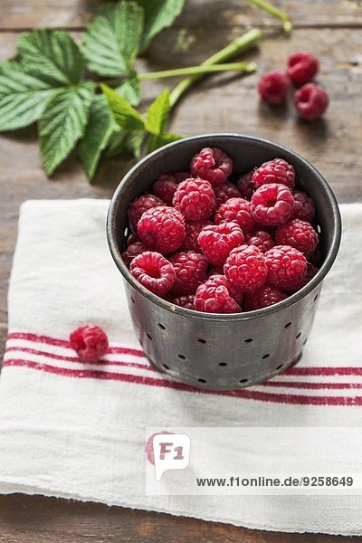 Fresh raspberries in a metal container