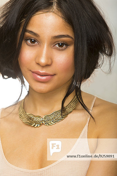Hispanic woman wearing gold necklace