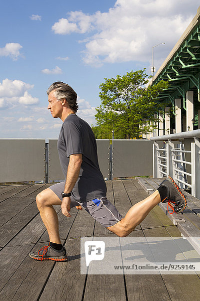 Caucasian man exercising on urban deck