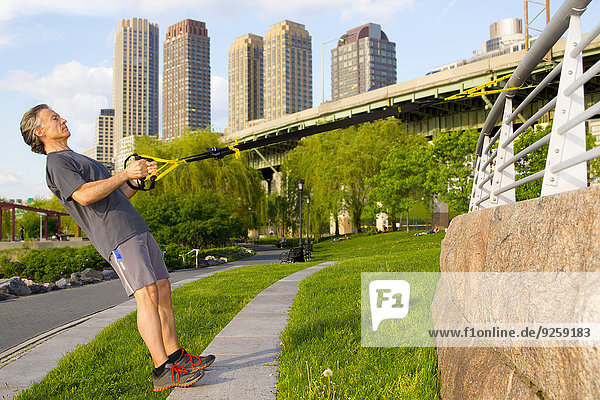 Caucasian man exercising in urban park