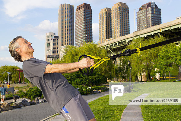Caucasian man exercising in urban park