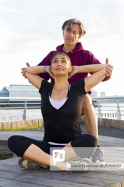 Couple exercising in waterfront park