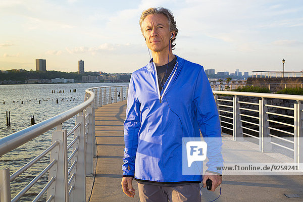 Caucasian man standing at urban waterfront