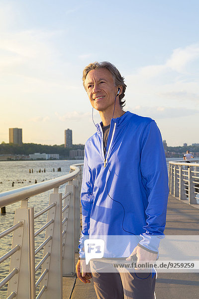 Caucasian man standing at urban waterfront