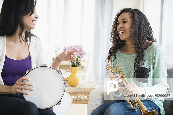 Mother and daughter playing music together