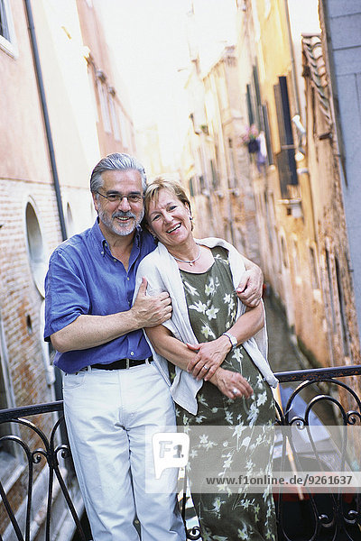 Senior couple hugging over urban canal  Venice  Veneto  Italy