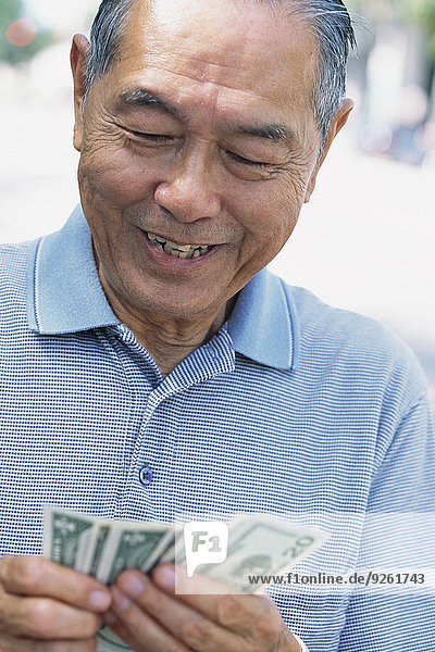 Außenaufnahme Senior Senioren Mann Geld zählen freie Natur