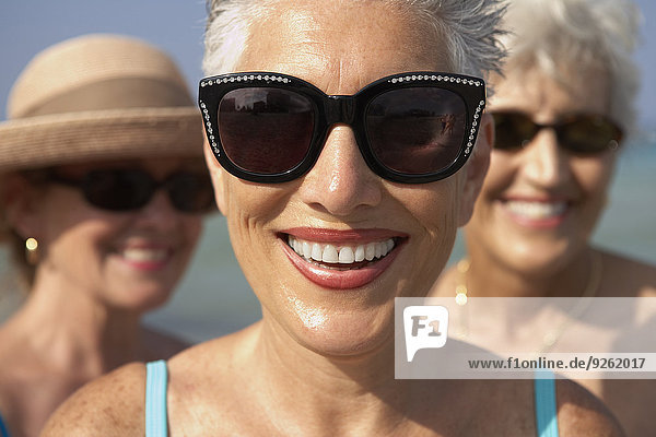 Senior woman wearing sunglasses on beach