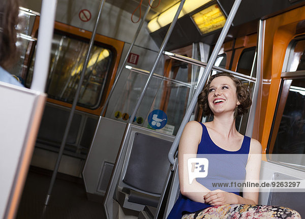 Happy young woman in a subway