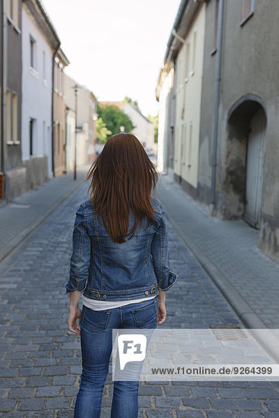Rear view of brunette woman in a street