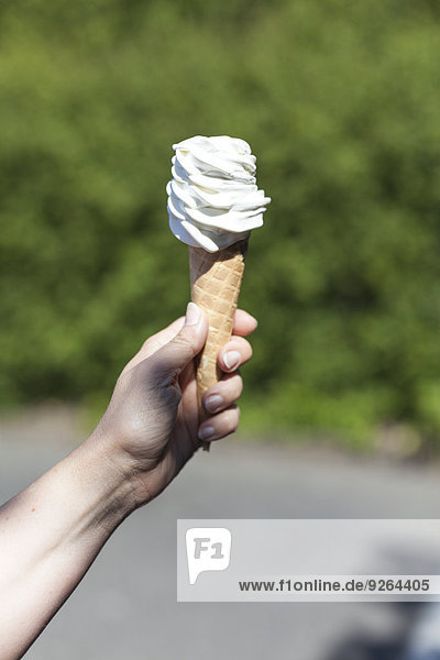 Woman's hand holding ice cream cone