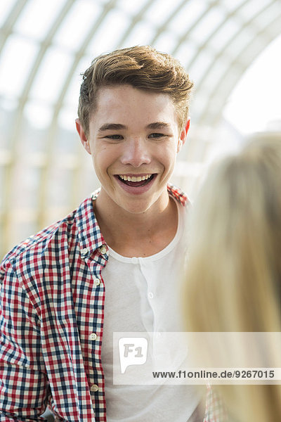 Smiling teenage boy at commuter train station