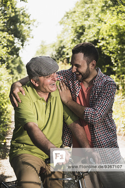 Portrait of father and son laughing together
