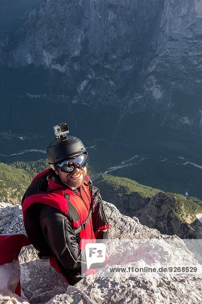Portrait of BASE jumper on mountain edge  Alleghe  Dolomites  Italy