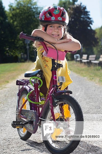 Young girl leaning on bicycle  portrait