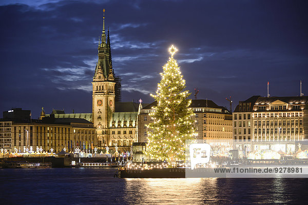 Binnenalster lake with Christmas tree and Town Hall at Christmas time  Hamburg  Germany