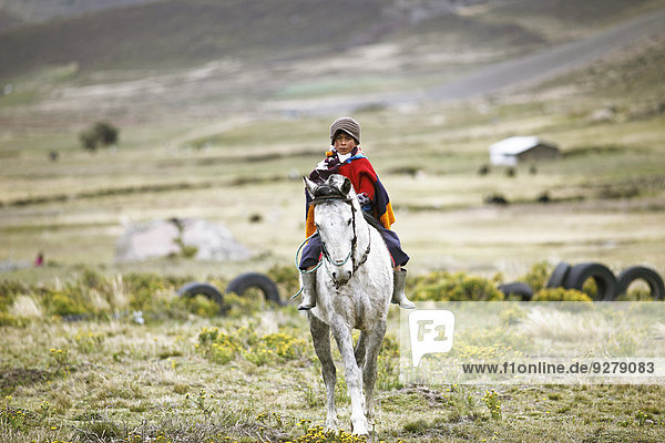 Boy from the Puruhá people riding on a horse  Kichwa  Chimborazo Province  Ecuador