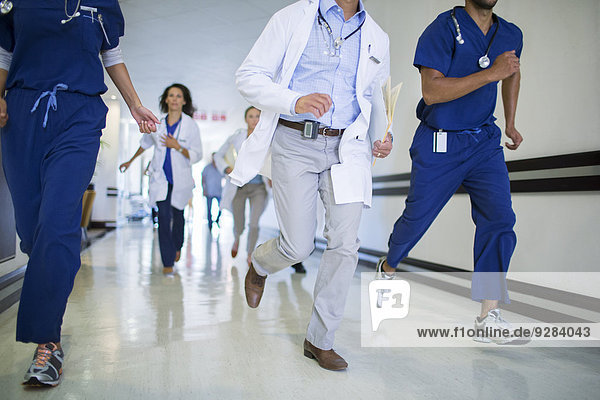 Doctors and nurses rushing in hospital hallway