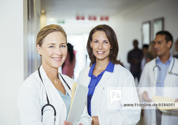 Doctors smiling in hospital hallway