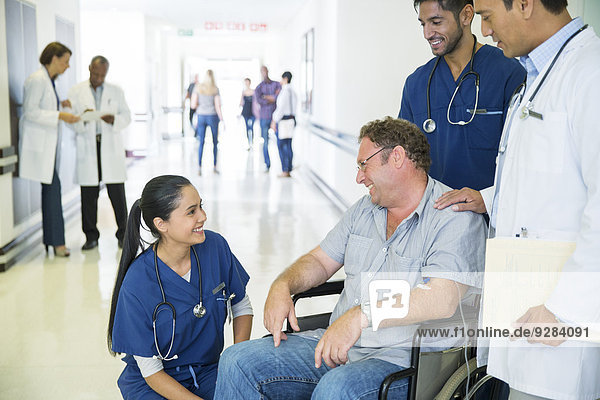 Doctor and nurses talking to patient in hospital