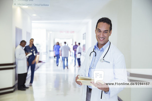 Doctor smiling in hospital hallway