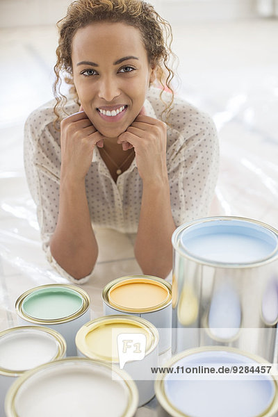 Woman sitting in front of paint cans