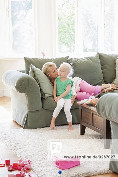 Mother with daughter on sofa