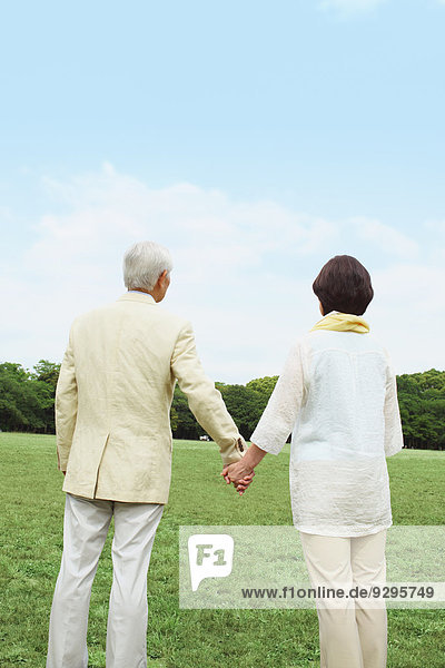 Senior adult Japanese couple in a park