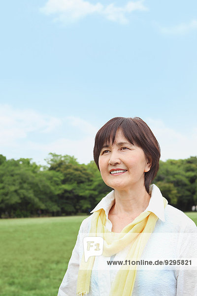 Senior adult Japanese woman in a park