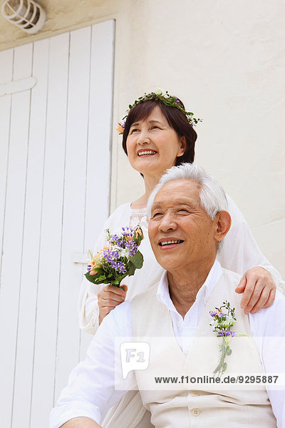 Senior adult Japanese couple celebrating