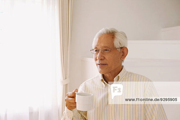 Senior adult Japanese man with coffee