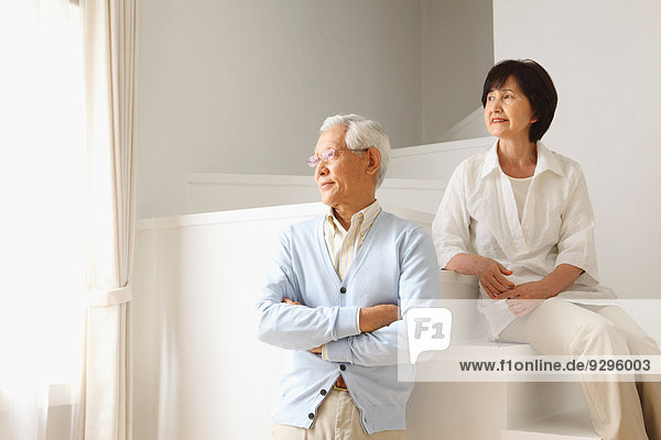 Senior adult Japanese couple in the living room
