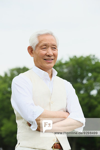 Senior adult Japanese man in a park
